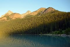 01 Lake Agnes Trail Contours Through The Trees To The Lake Just To The Right Of The Big Beehive With Mount Whyte, Mount Niblock and Mount St Piran Early Morning.jpg